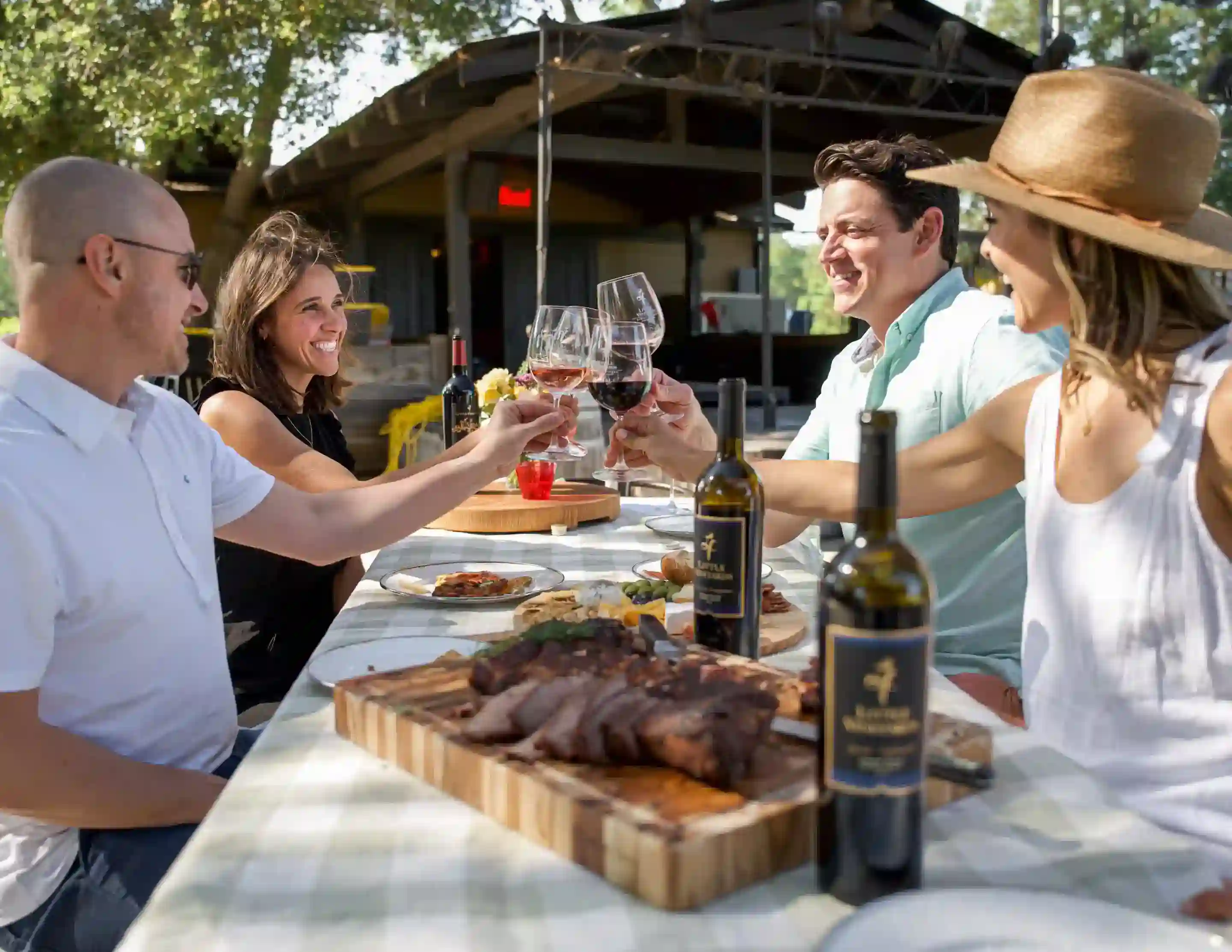 Friends enjoying a Sonoma wine club gift membership with red wine, food, and music at Little Vineyards in Sonoma Valley.