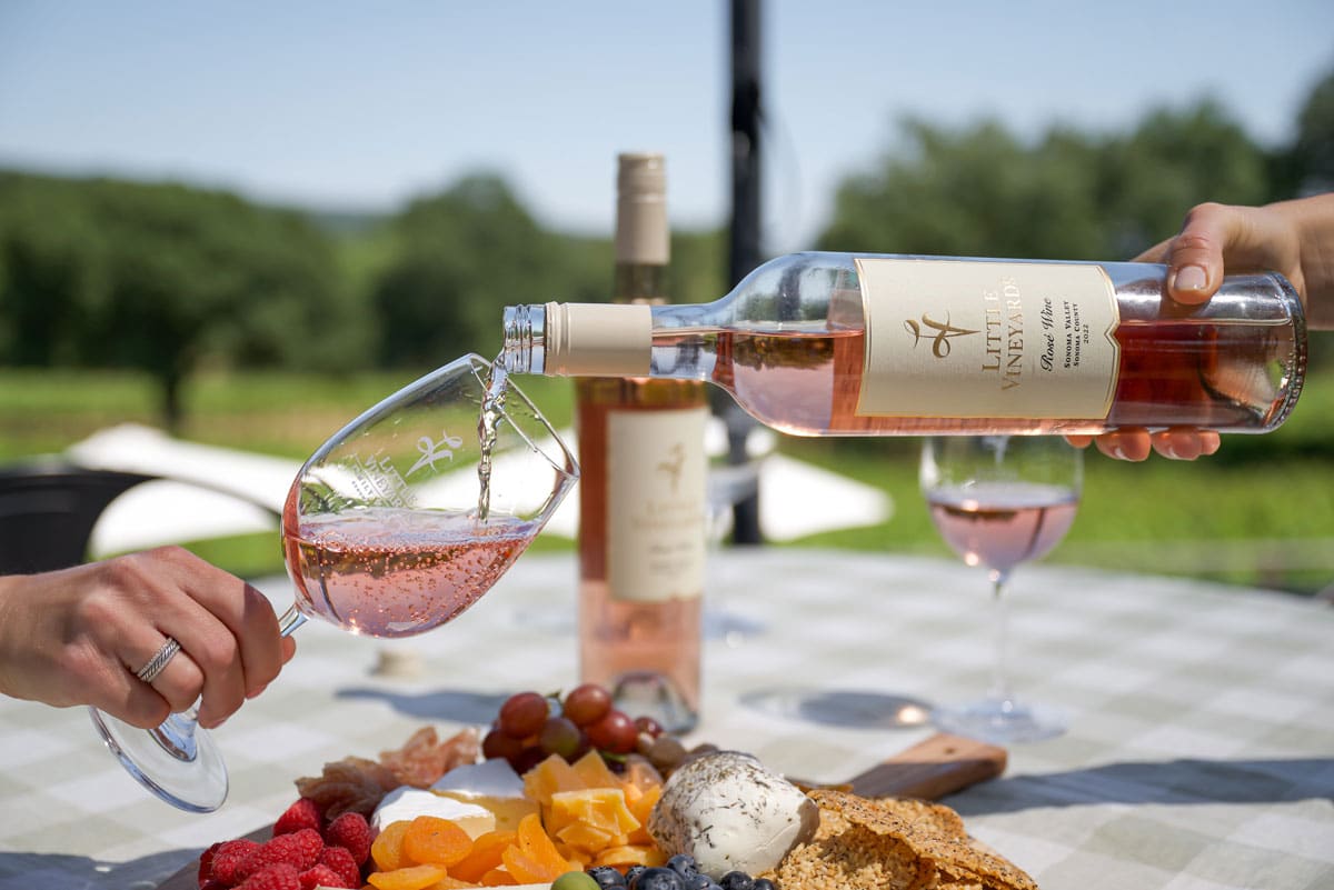 Rose being poured outside on a nice summer day at Little Vineyards Winery