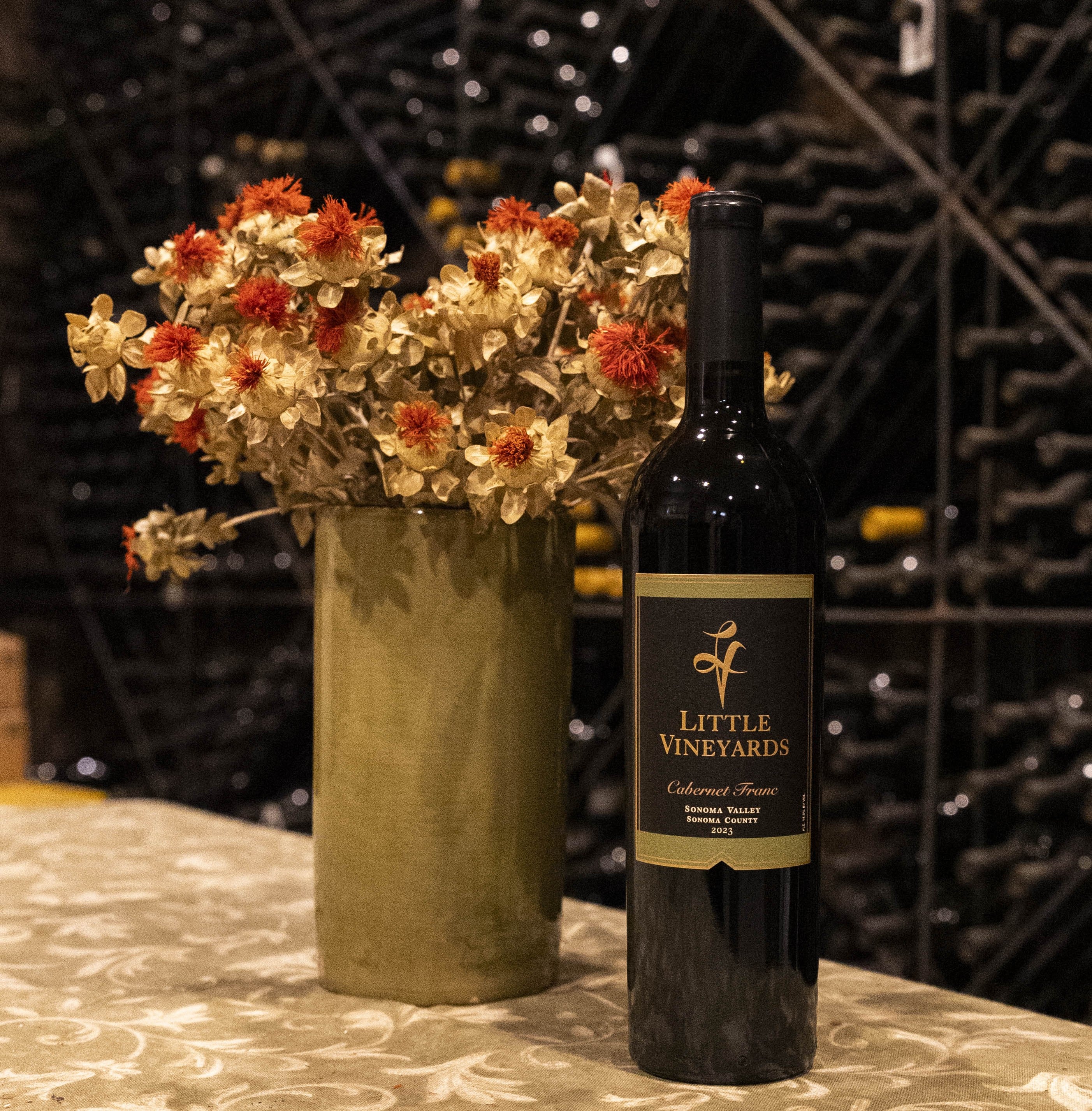 Bottle of wine with flowers on a bar